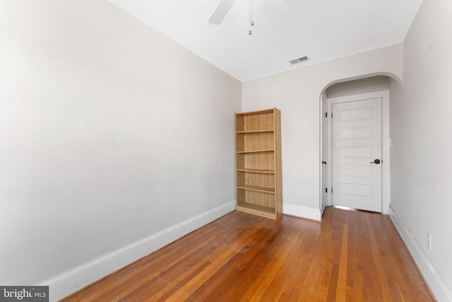 unfurnished bedroom with ceiling fan and wood-type flooring