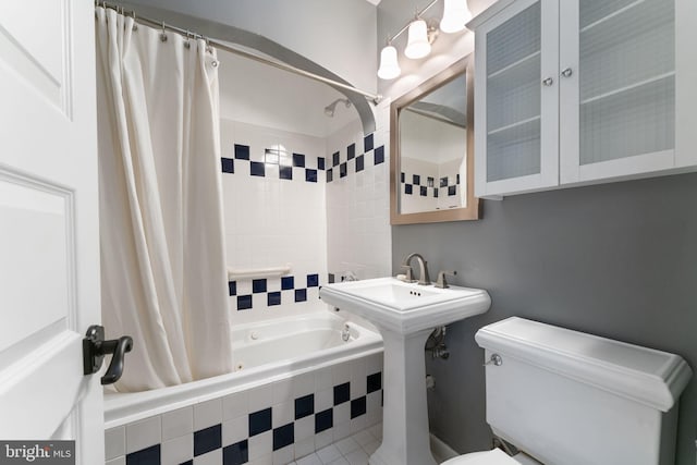 bathroom with toilet and shower / tub combo with curtain