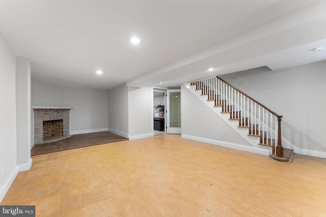 unfurnished living room with light colored carpet and a brick fireplace