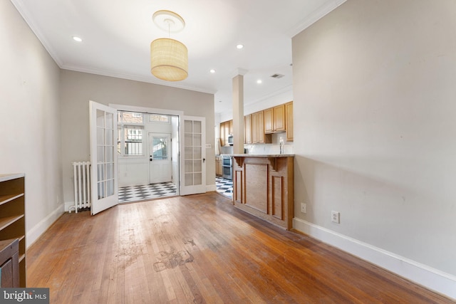 entrance foyer featuring french doors, radiator heating unit, dark hardwood / wood-style flooring, and crown molding