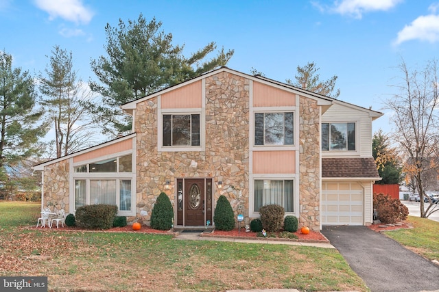 view of front of property featuring a garage and a front lawn