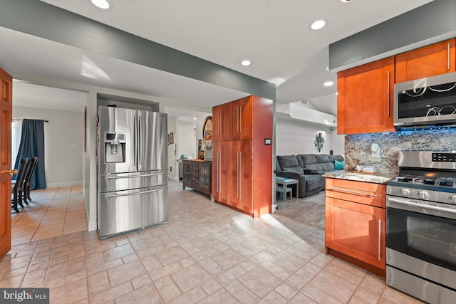 kitchen featuring stainless steel appliances and tasteful backsplash