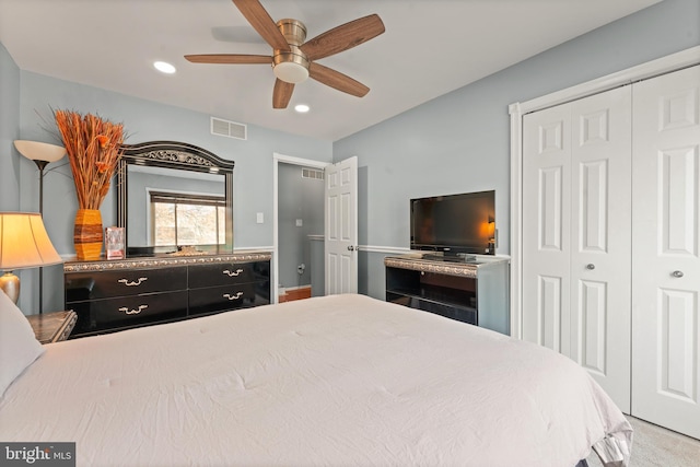 carpeted bedroom featuring a closet and ceiling fan