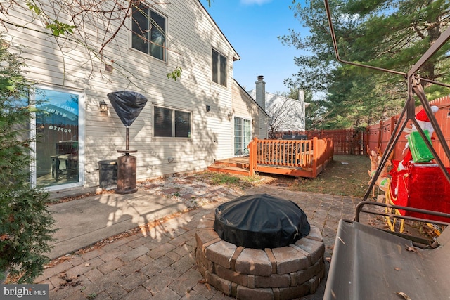 view of patio / terrace featuring a wooden deck and a fire pit