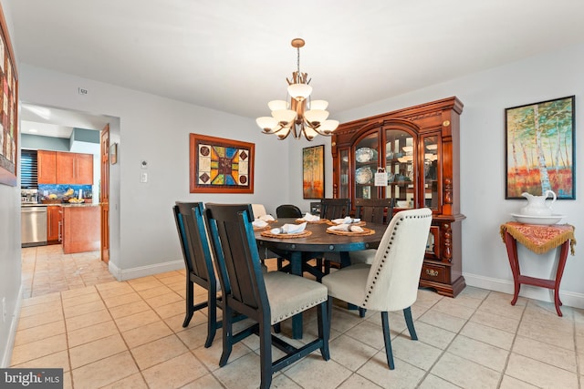 dining area with light tile patterned floors and a chandelier