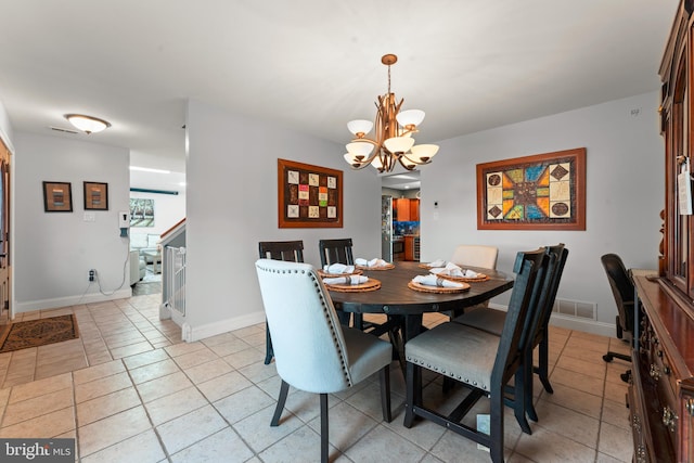 tiled dining area with an inviting chandelier