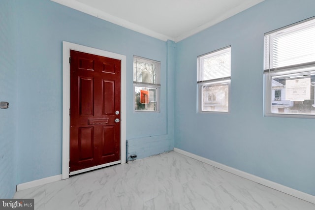 foyer featuring crown molding