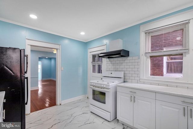 kitchen with black refrigerator, decorative backsplash, ventilation hood, electric range, and white cabinets