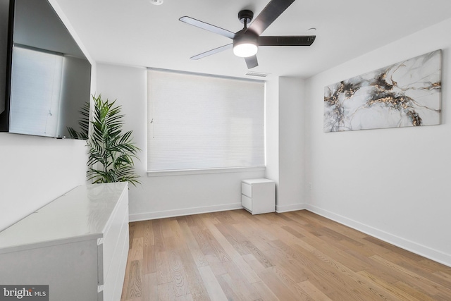 unfurnished room with ceiling fan and light hardwood / wood-style floors