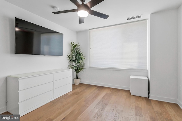 unfurnished room with ceiling fan and light wood-type flooring