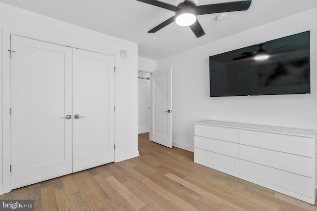 unfurnished bedroom featuring a closet, light hardwood / wood-style floors, and ceiling fan