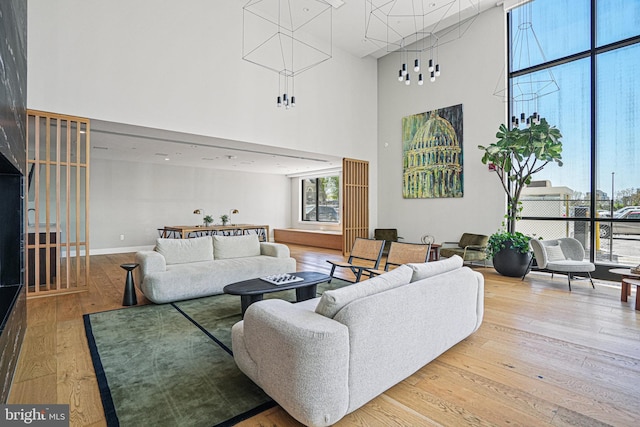 living room featuring hardwood / wood-style flooring and a towering ceiling