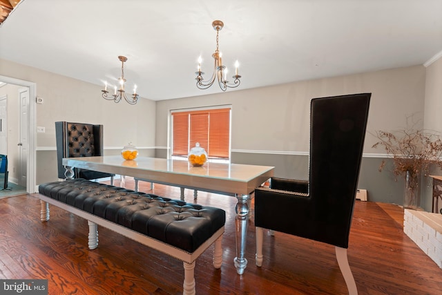 dining room featuring hardwood / wood-style flooring and an inviting chandelier