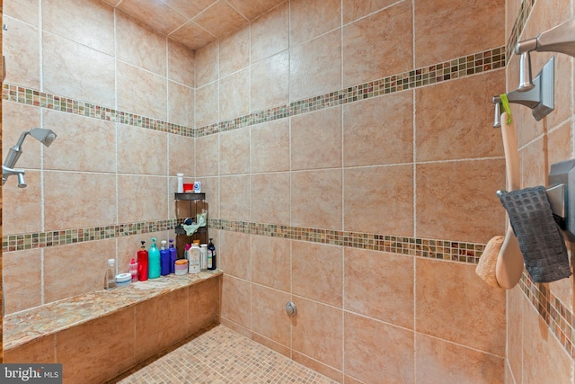 bathroom with a tile shower