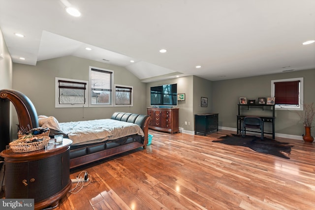 bedroom featuring light hardwood / wood-style flooring and lofted ceiling