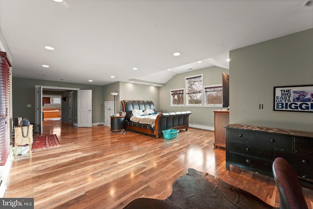 bedroom with light hardwood / wood-style floors and lofted ceiling