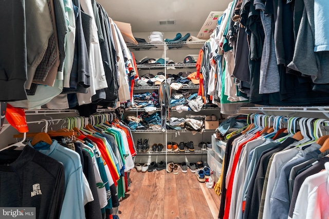 spacious closet featuring hardwood / wood-style floors