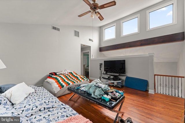 living room with ceiling fan, high vaulted ceiling, and hardwood / wood-style flooring