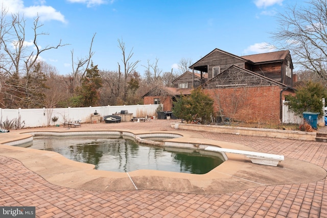 view of pool featuring a diving board, an in ground hot tub, and a patio