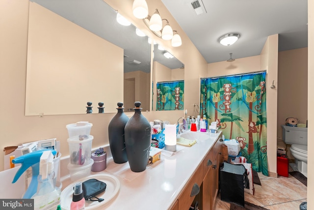 bathroom featuring vanity, toilet, and walk in shower