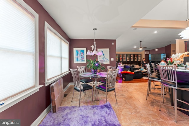 tiled dining space featuring radiator heating unit and ceiling fan