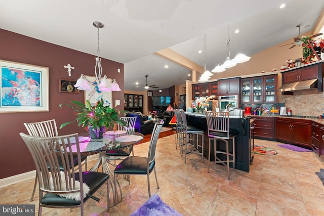 dining space featuring beamed ceiling and ceiling fan