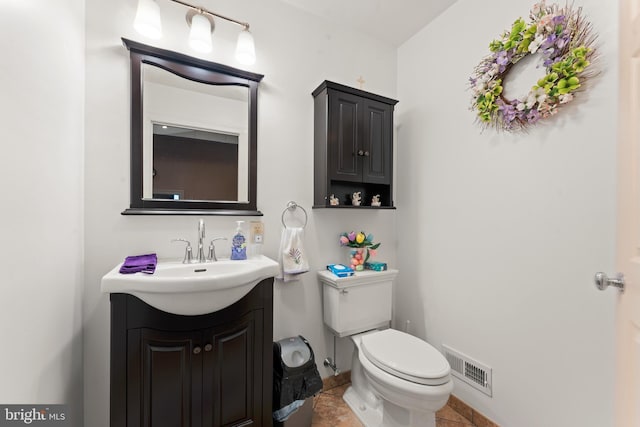 bathroom featuring tile patterned flooring, vanity, and toilet