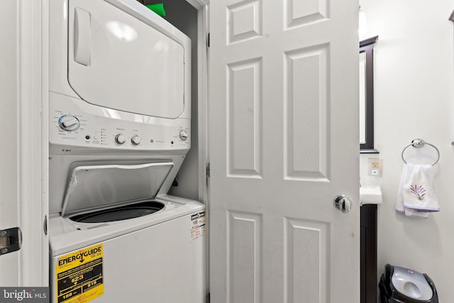 clothes washing area featuring stacked washer and dryer