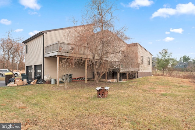 rear view of property featuring a yard and a deck