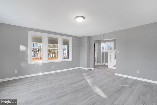 unfurnished room with light wood-type flooring