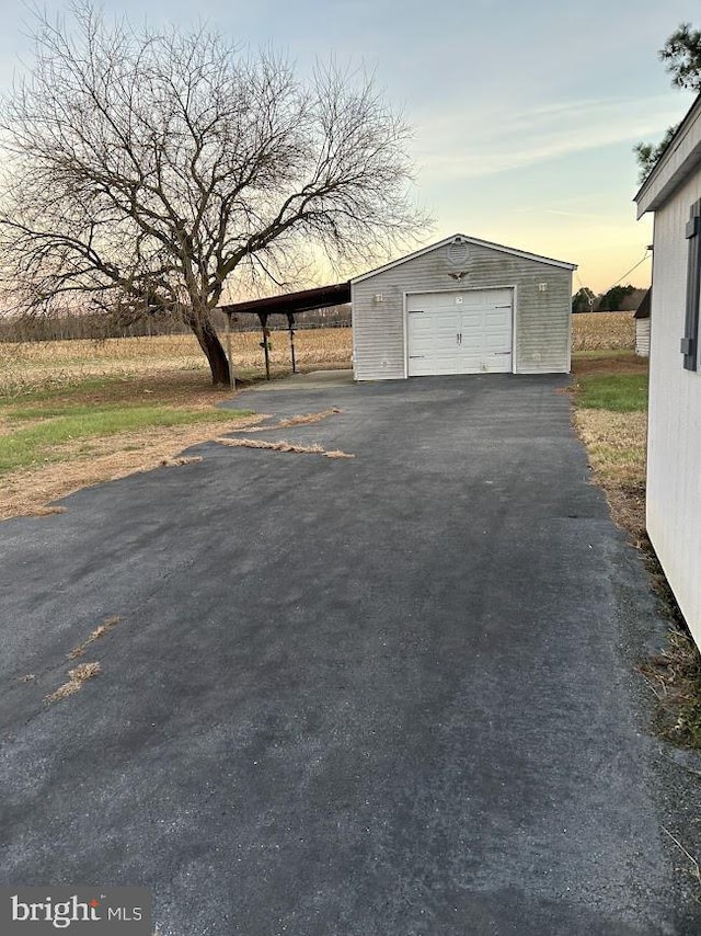 view of garage at dusk