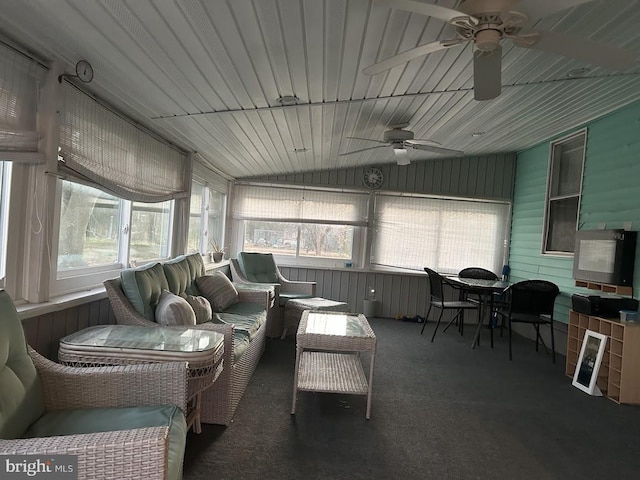 sunroom featuring ceiling fan, plenty of natural light, and lofted ceiling