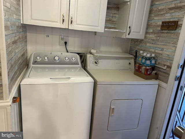 washroom with cabinets and separate washer and dryer