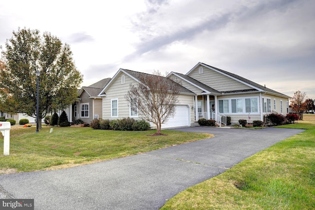 ranch-style house featuring a front yard and a garage