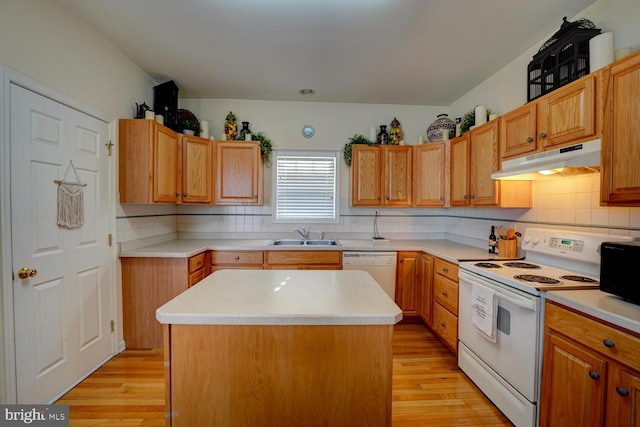 kitchen with decorative backsplash, white appliances, sink, light hardwood / wood-style flooring, and a kitchen island