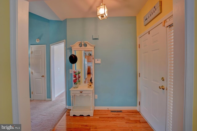 foyer entrance featuring light hardwood / wood-style flooring and lofted ceiling