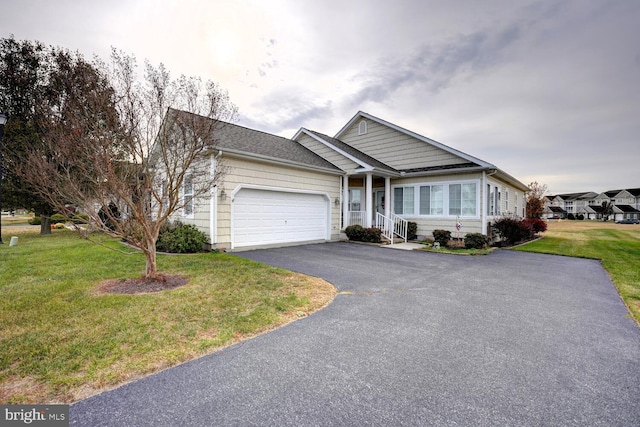 view of front of home featuring a front yard and a garage