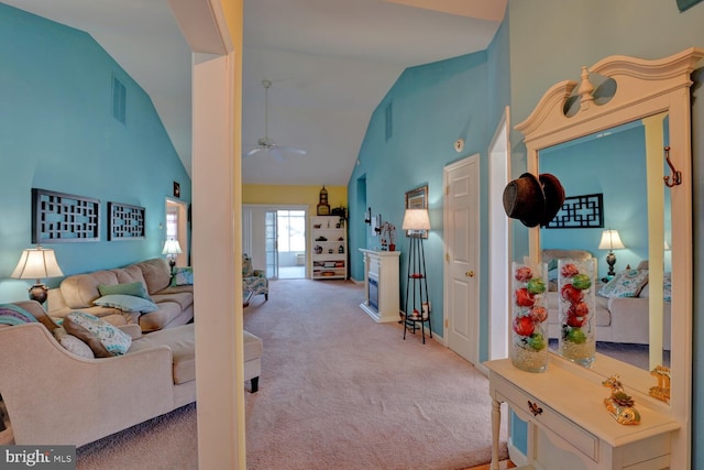 carpeted living room featuring high vaulted ceiling and ceiling fan