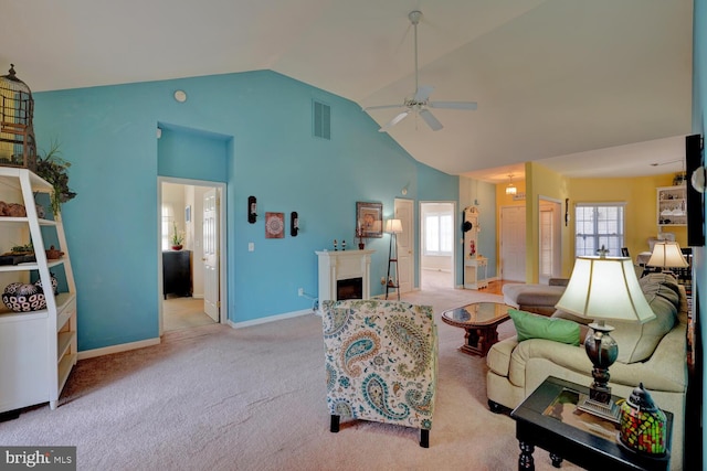 carpeted living room featuring ceiling fan and vaulted ceiling