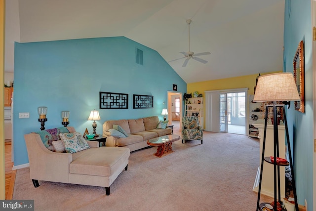 carpeted living room featuring ceiling fan and high vaulted ceiling