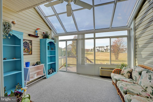 sunroom / solarium with a wall unit AC, ceiling fan, and lofted ceiling with skylight