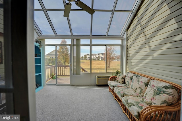 sunroom / solarium with a wall mounted AC, a wealth of natural light, ceiling fan, and lofted ceiling