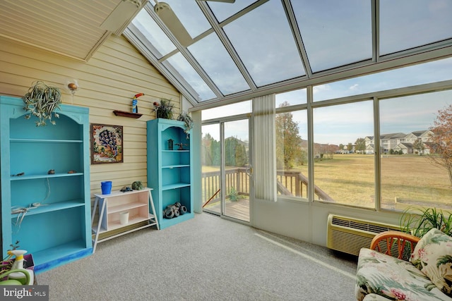 sunroom / solarium with an AC wall unit, lofted ceiling with skylight, and a healthy amount of sunlight