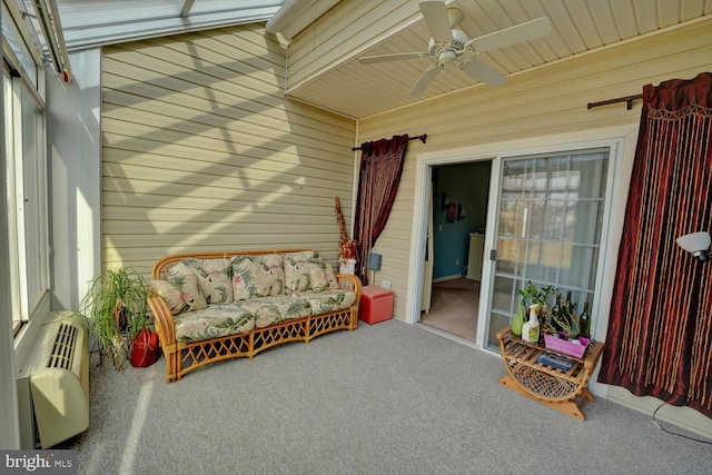 sunroom / solarium with an AC wall unit and ceiling fan