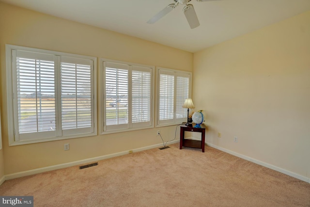 unfurnished room with ceiling fan and light colored carpet