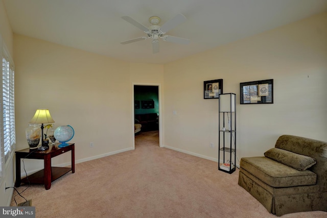 living area featuring ceiling fan and light colored carpet