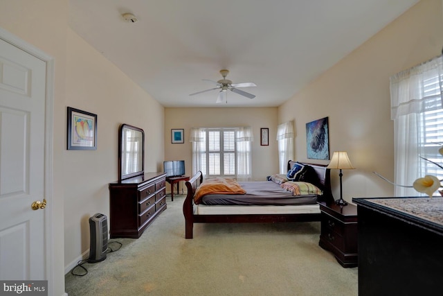 carpeted bedroom with multiple windows and ceiling fan