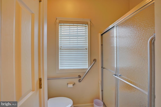 bathroom with toilet and walk in shower