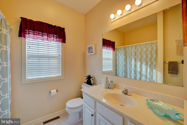 bathroom featuring tile patterned flooring, vanity, and toilet