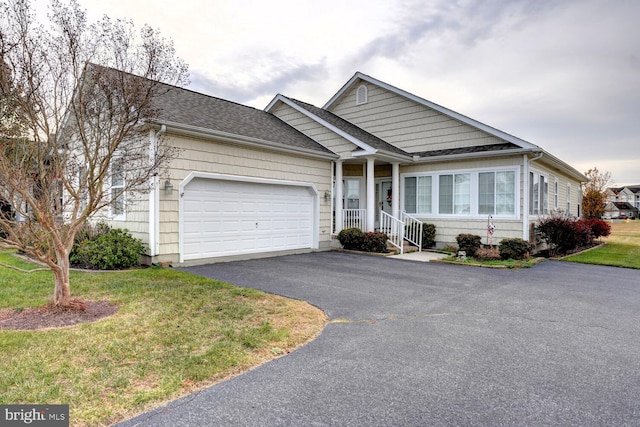 view of front of property featuring a garage and a front lawn